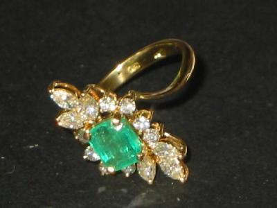 Appraisal: AN EMERALD AND DIAMOND DRESS RING the trapp cut emerald