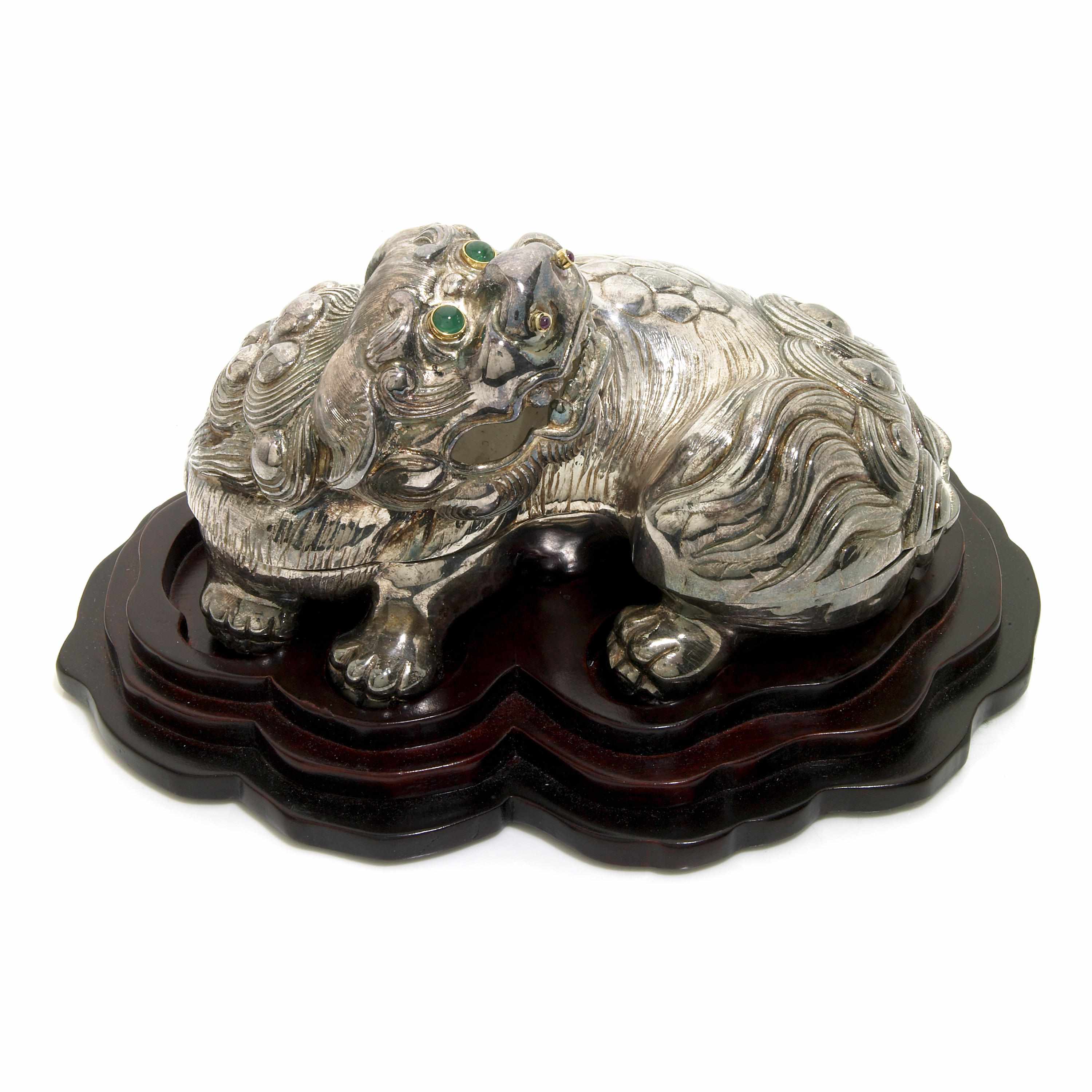 Appraisal: A sterling silver Foo Dog container with a wooden stand