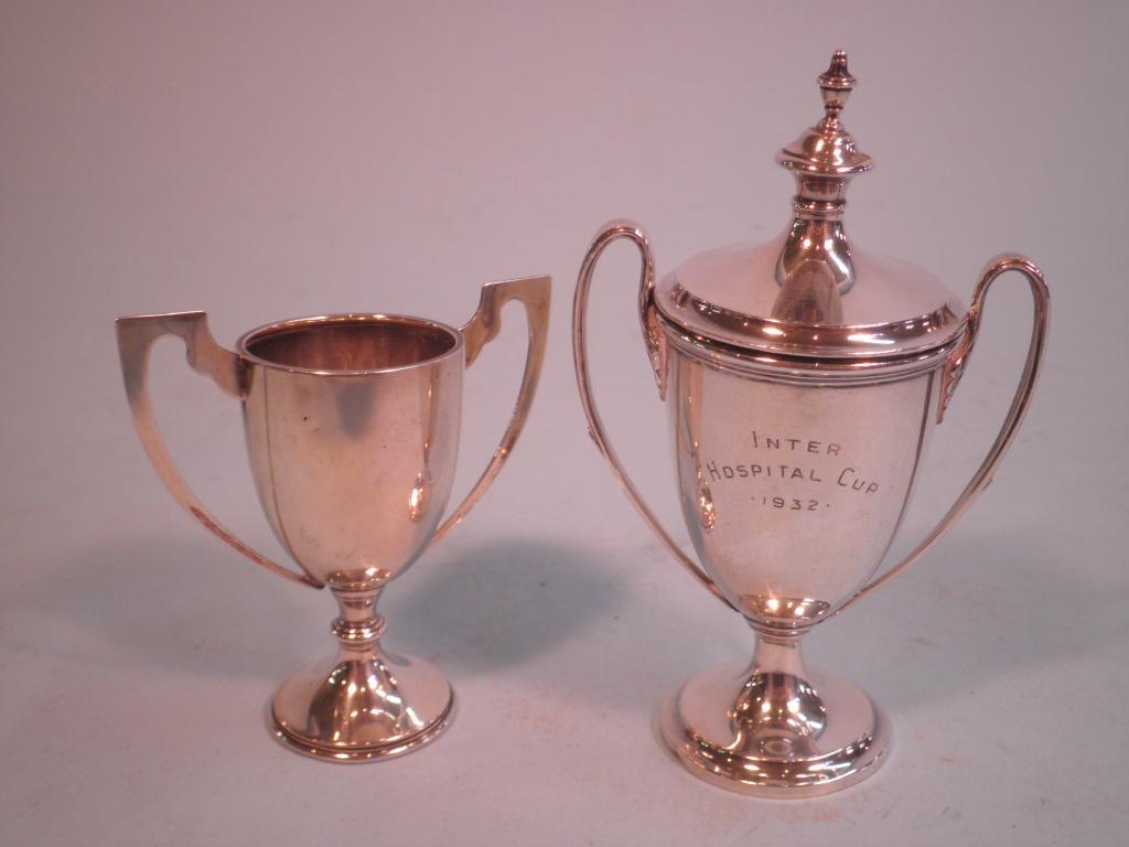 Appraisal: A silver trophy cup and cover with an urn shaped