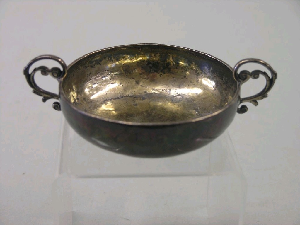 Appraisal: An early silver porringer with scroll handles engraved with initials