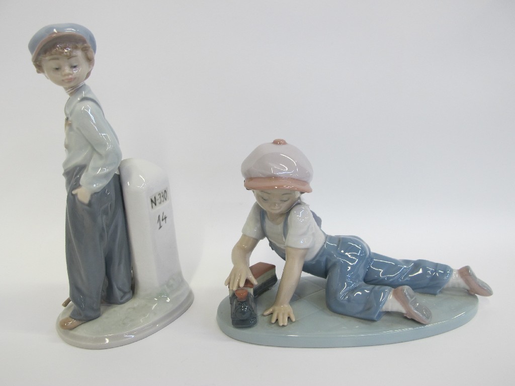 Appraisal: Tw o Lladro figures of boys