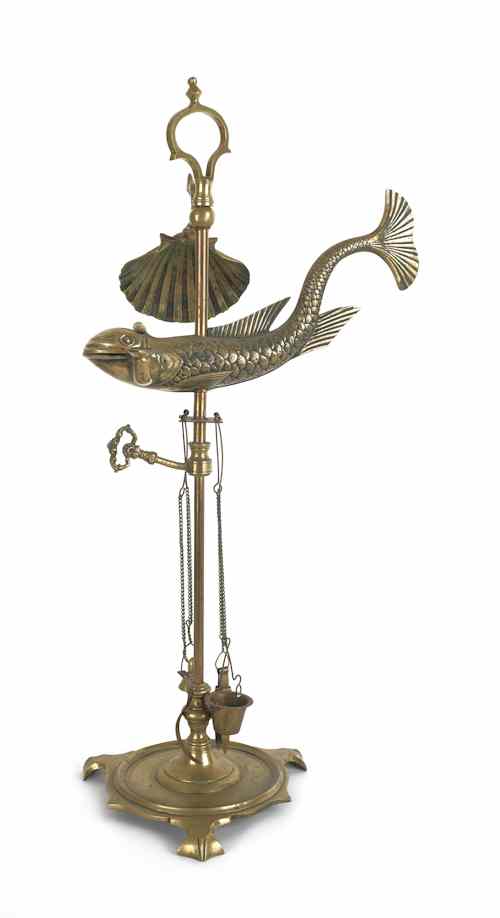 Appraisal: Brass dolphin fat lamp th c with shell form shade