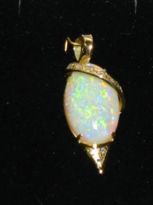 Appraisal: AN OPAL AND DIAMOND PENDANT the cabochon oval set within