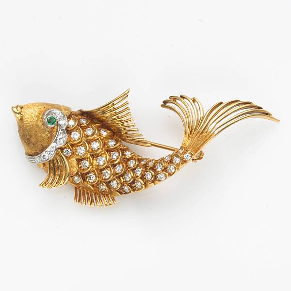 Appraisal: A diamond emerald and eighteen karat gold fish brooch