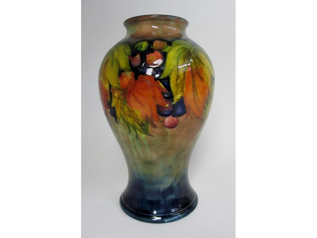 Appraisal: A Moorcroft Grape and Leaf pattern baluster vase on blue