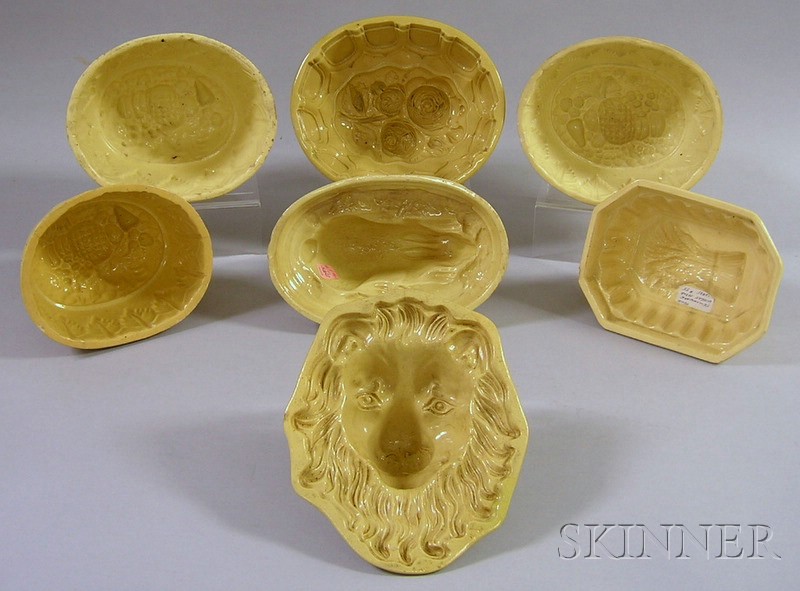 Appraisal: Seven Yellowware Culinary Molds lion mask-form a sheaf of wheat