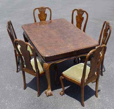 Appraisal: RICHLY GRAINED BURLED WALNUT DINING TABLE AND CHAIRS Draw leaf