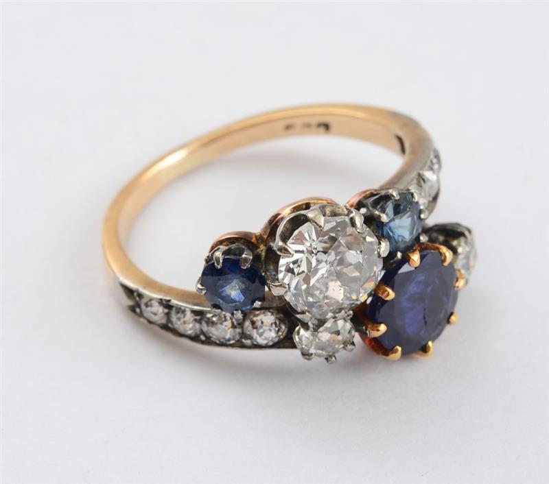 Appraisal: K GOLD DIAMOND AND SAPPHIRE CROSSOVER RING Diamonds weighing carats