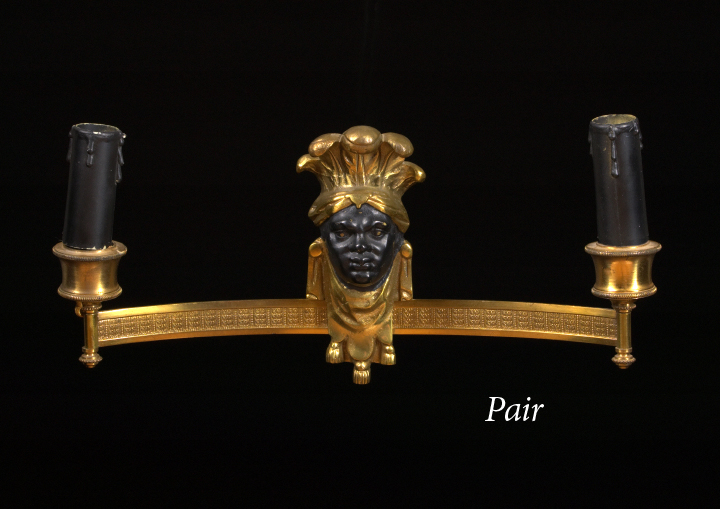 Appraisal: Stylish Pair of French Parcel-Ebonized Gilt-Brass Two-Light Blackamoor Masque Appliques