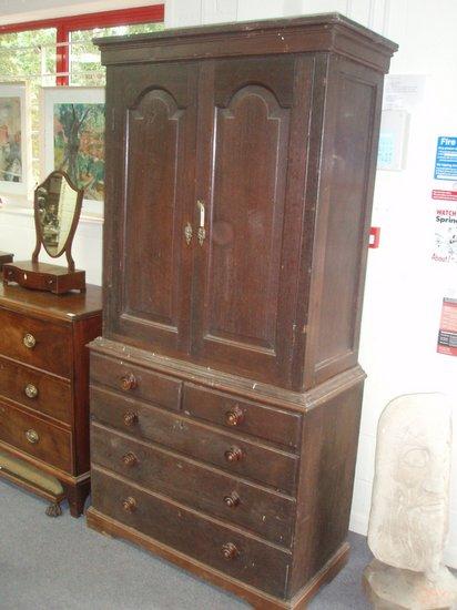 Appraisal: A late th Century oak wardrobe the top with moulded