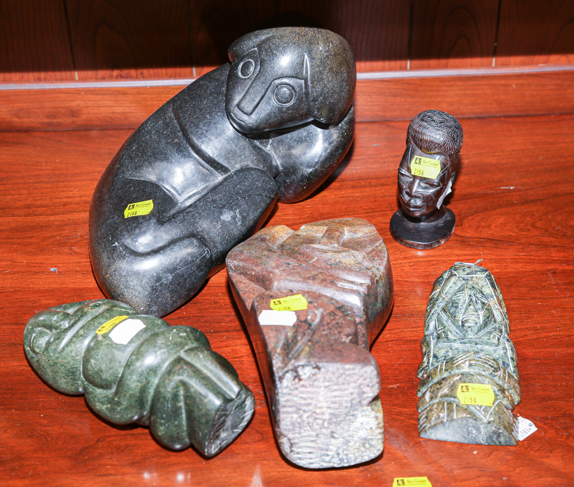 Appraisal: FOUR ABSTRACT SHONA SOAPSTONE CARVINGS With a Makonde carved wood