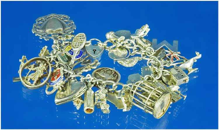 Appraisal: Silver Charm Bracelet Loaded With Approx Charms Comprising Bird Cage