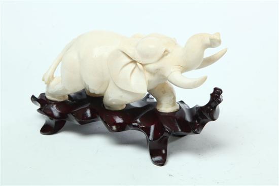 Appraisal: CARVED IVORY ELEPHANT Asian early th century Charging elephant with