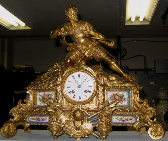 Appraisal: CONTINENTAL GILT METAL FIGURAL MANTLE CLOCK Showing a large warrior