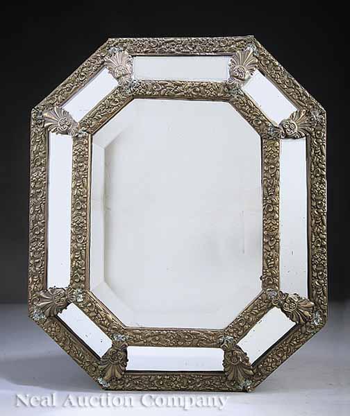 Appraisal: A Decorative Brass Repouss Cushion Mirror frame with shells interspersed