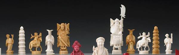 Appraisal: A small tinted ivory chess set with a foldable chess