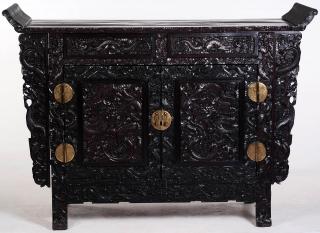 Appraisal: A LARGE HEAVILY CARVED CHINESE ZITAN ALTAR COFFER The panel