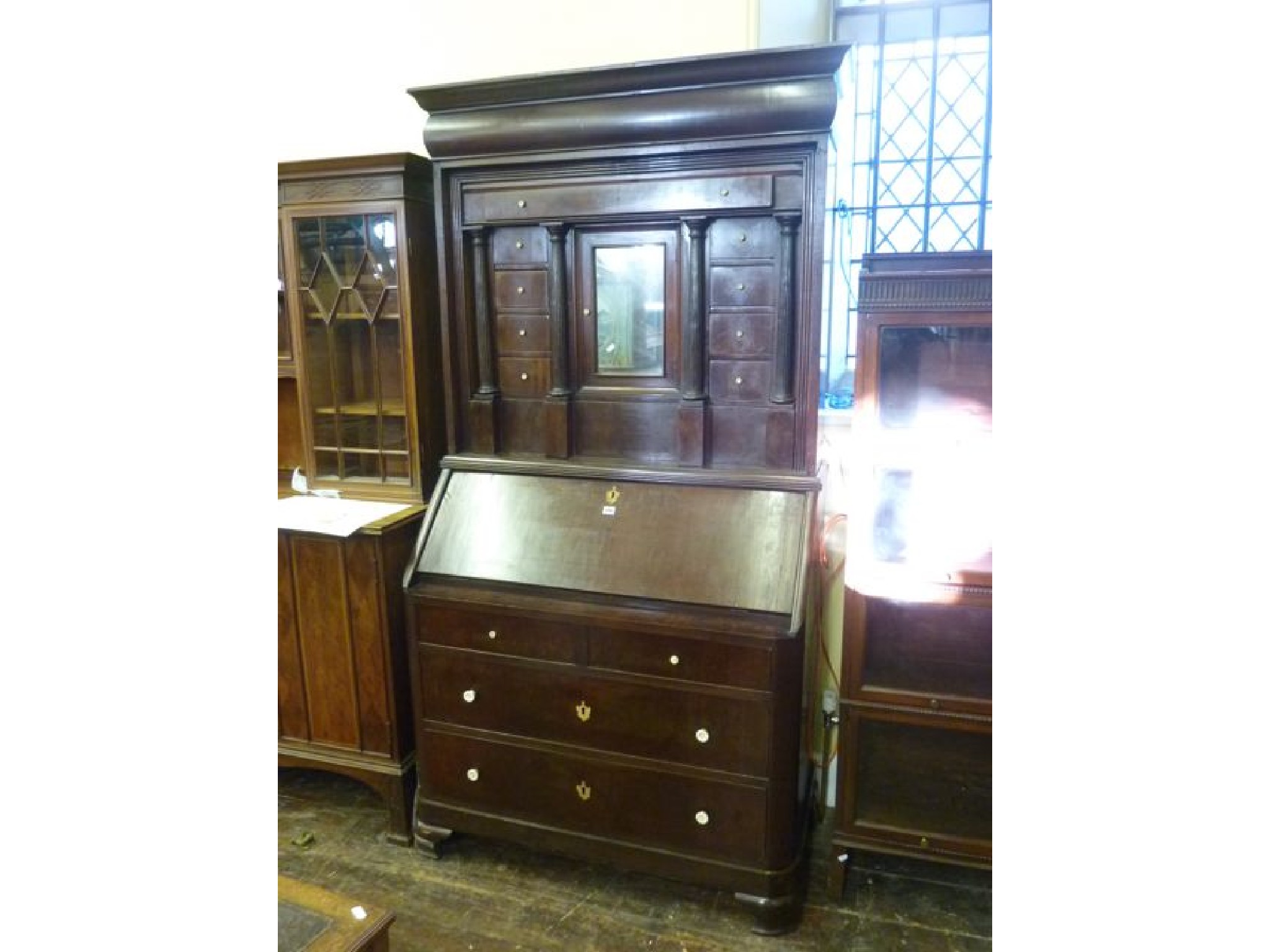 Appraisal: A th century continental mahogany bureau cabinet the bureau fitted