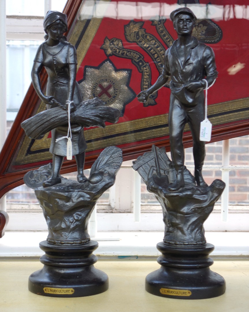 Appraisal: A pair of patinated metal figures th century emblematic of