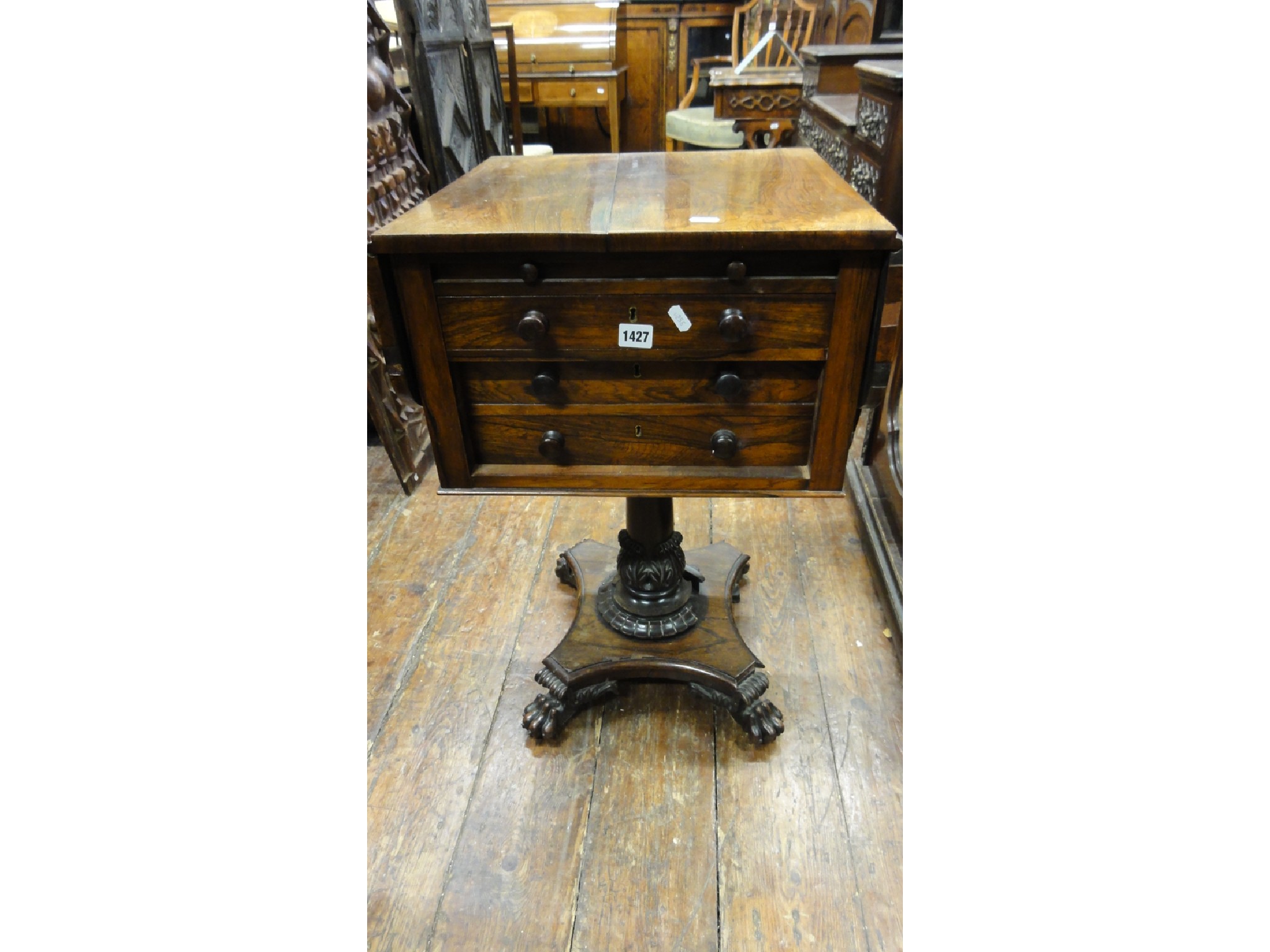 Appraisal: A Regency rosewood drop leaf ladies work table raised on