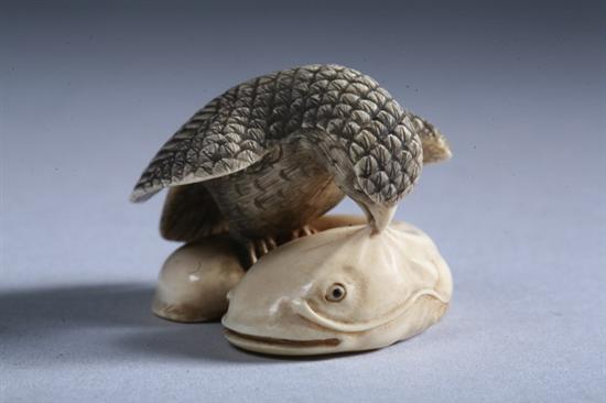 Appraisal: JAPANESE IVORY NETSUKE OF EAGLE EATING FISH - in long