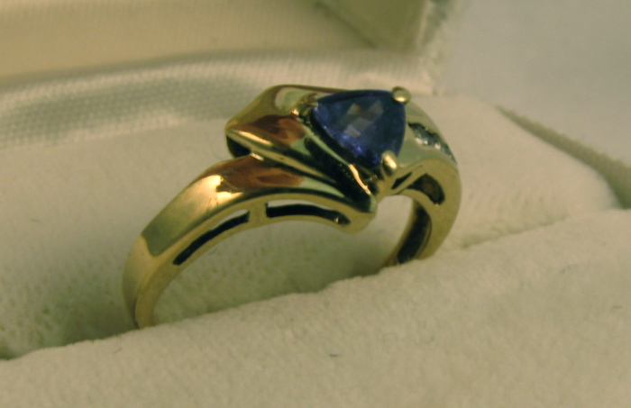 Appraisal: TANZANITE DIAMOND AND FOURTEEN KARAT GOLD RING set with a