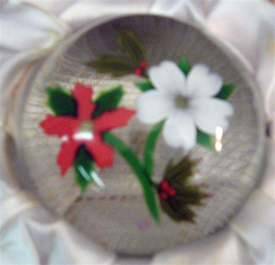 Appraisal: Perthshire glass Christmas paperweight containing a poinsettia Christmas rose and