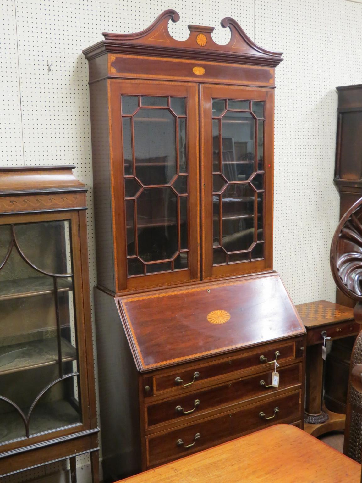 Appraisal: An Edwardian inlaid mahogany bureau bookcase swan-neck pediment above a