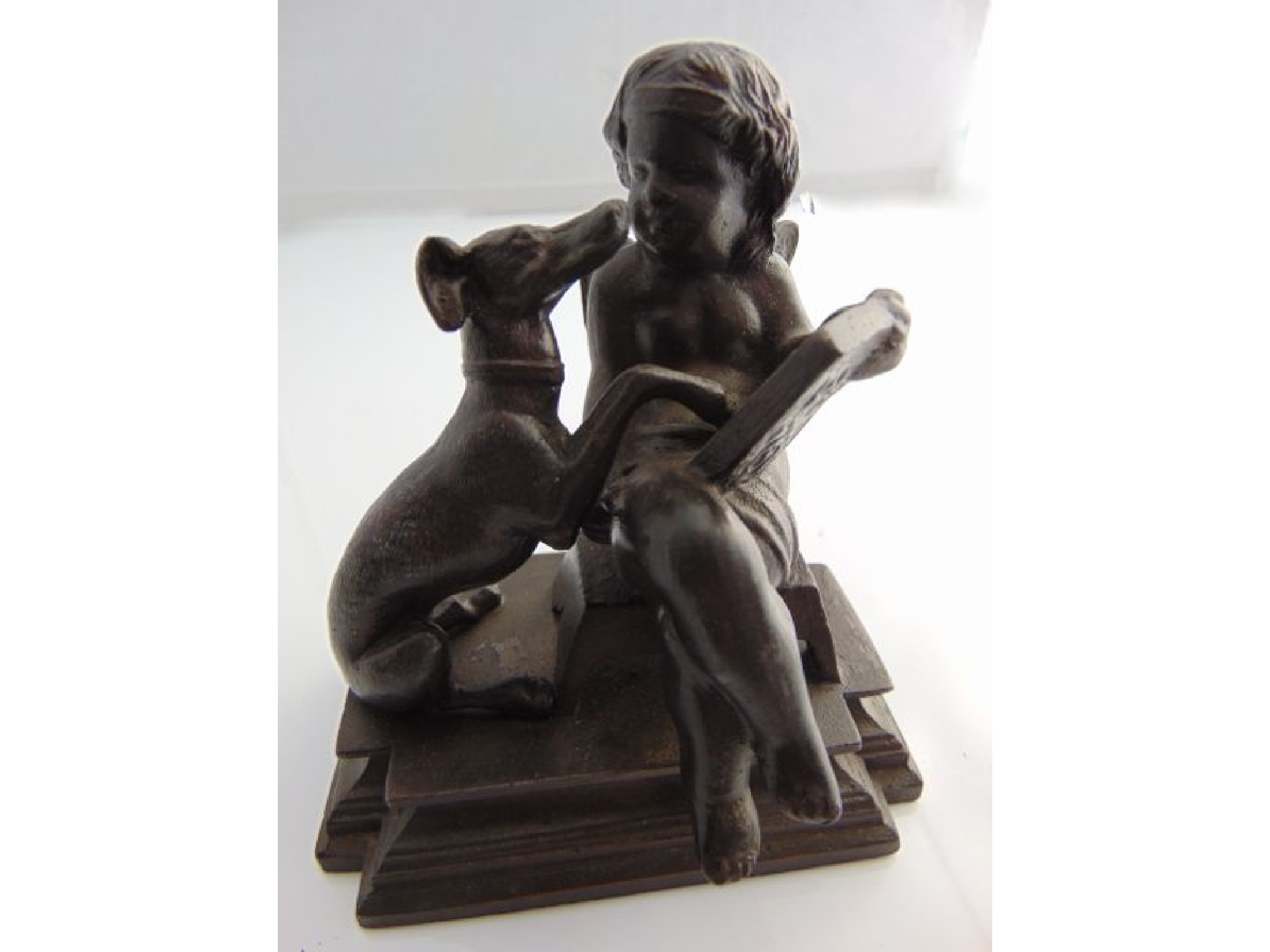 Appraisal: th century German cast iron group cherub and whippet raised