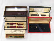 Appraisal: A set of two red lacquer fountain pens with gilt