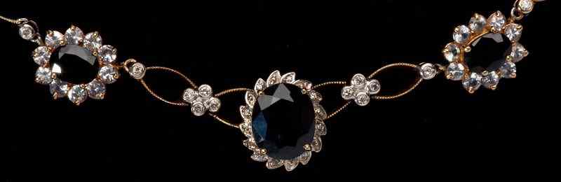 Appraisal: Sapphire and Diamond Line Necklacecentering on one oval sapphire x