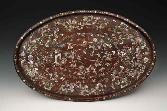 Appraisal: A CHINESE HARDWOOD OVAL TRAY with intricate mother of pearl