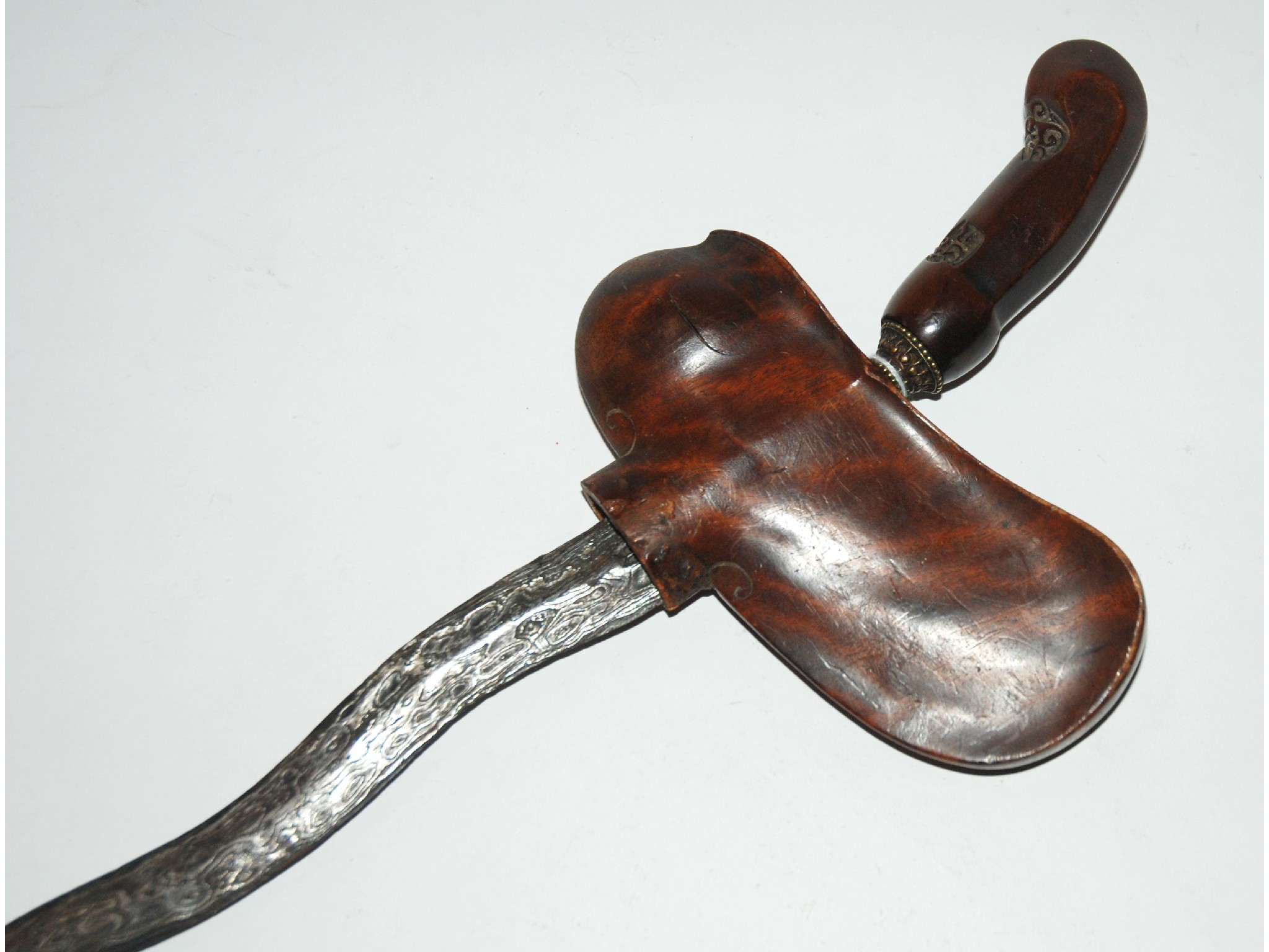 Appraisal: A Malayan kris with damascene blade and carved wood handle