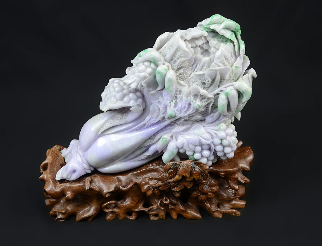 Appraisal: CHINESE CARVED JADEITE CABBAGE WITH GRAPES Lavender apple green and