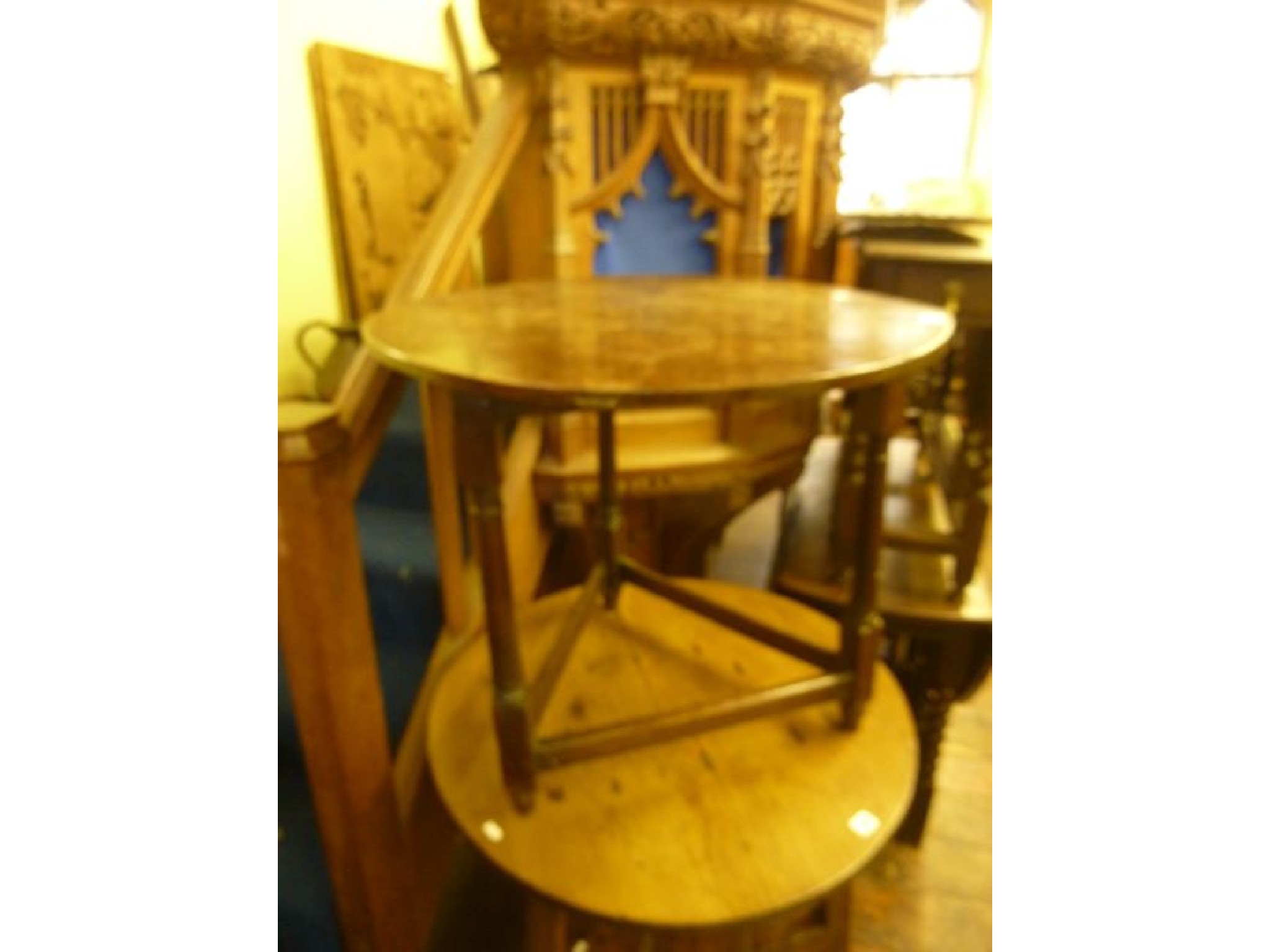 Appraisal: A Georgian oak cricket table the circular top raised on