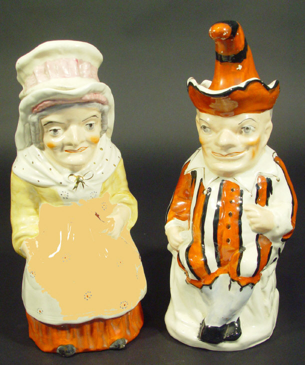 Appraisal: Pair of th century Staffordshire Punch and Judy Toby jugs