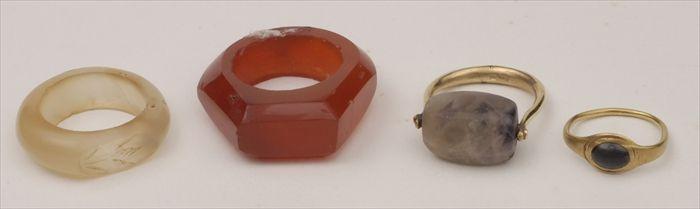 Appraisal: FOUR RINGS Ancient-style child's ring Egyptian-style ring and two hardstone