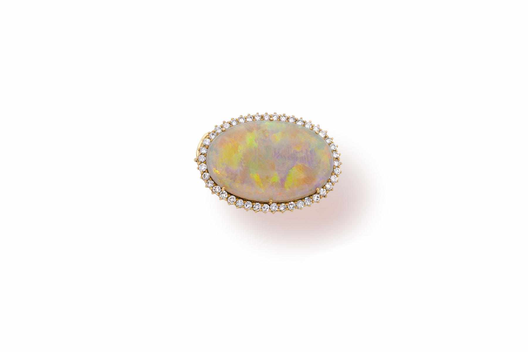 Appraisal: An opal and diamond pendant brooch centering an oval-shaped opal