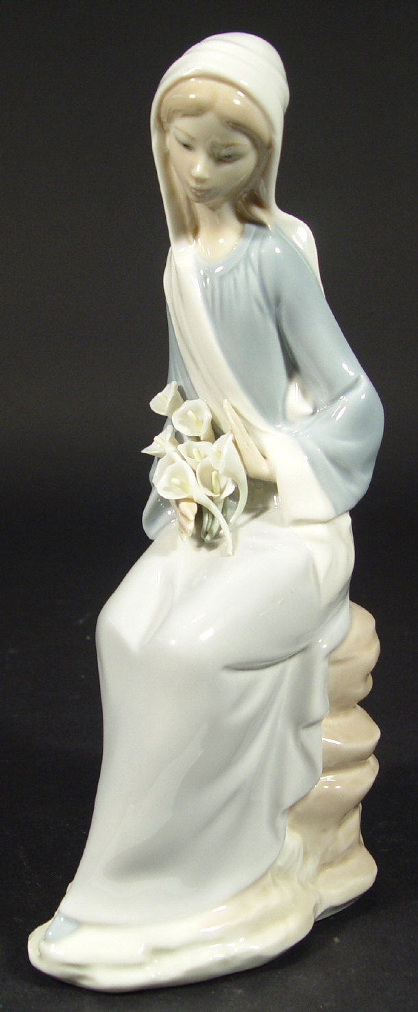 Appraisal: Lladro porcelain robed figurine clutching flowers printed factory mark to