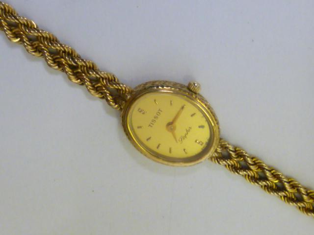 Appraisal: A LADY'S CT GOLD TISSOT WRISTWATCH the oval gilt dial