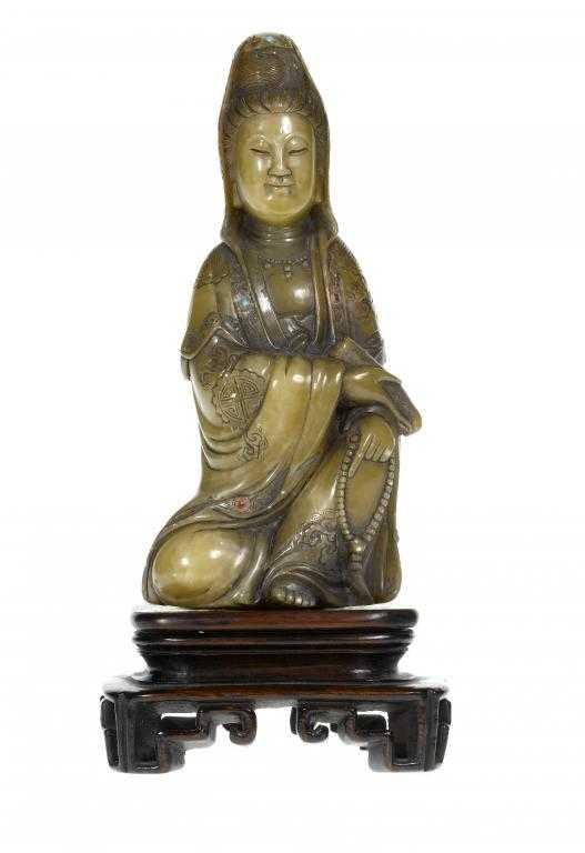 Appraisal: A CHINESE CARVED STONE FIGURE OF GUANYIN the goddess with