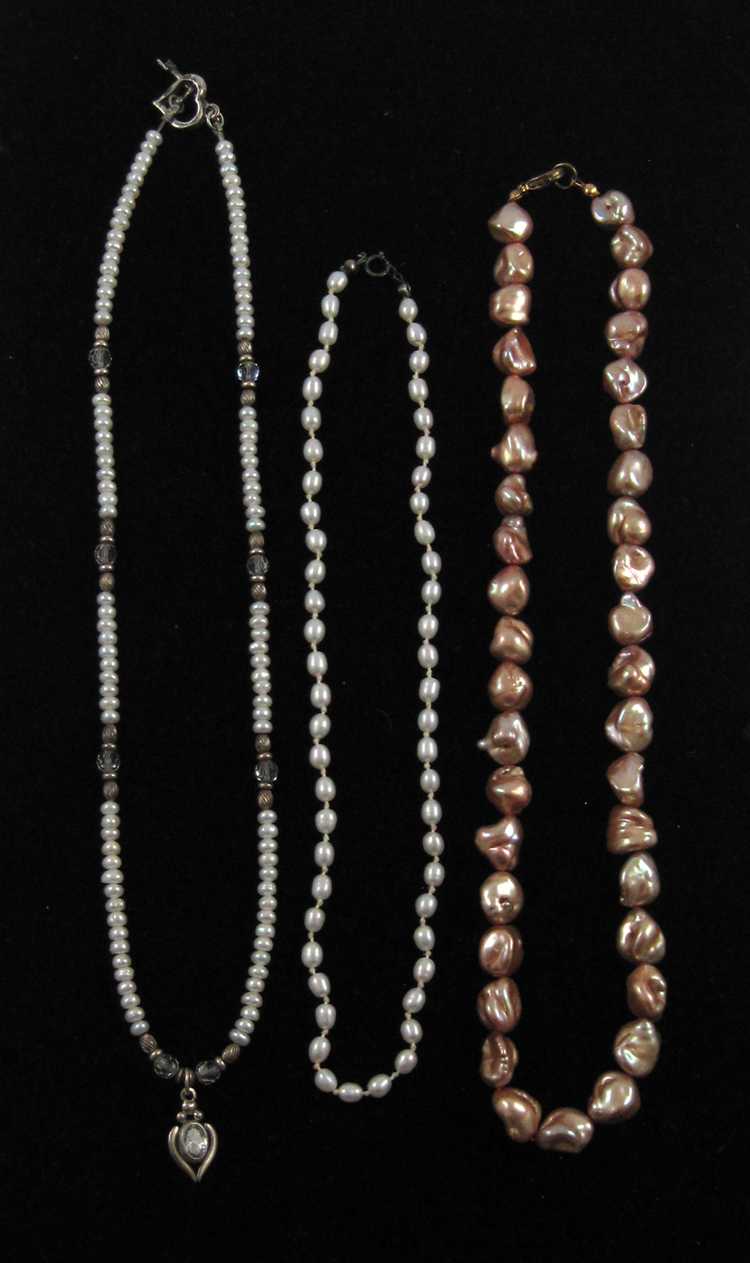 Appraisal: THREE FRESHWATER PEARL NECKLACES the first a peach color baroque