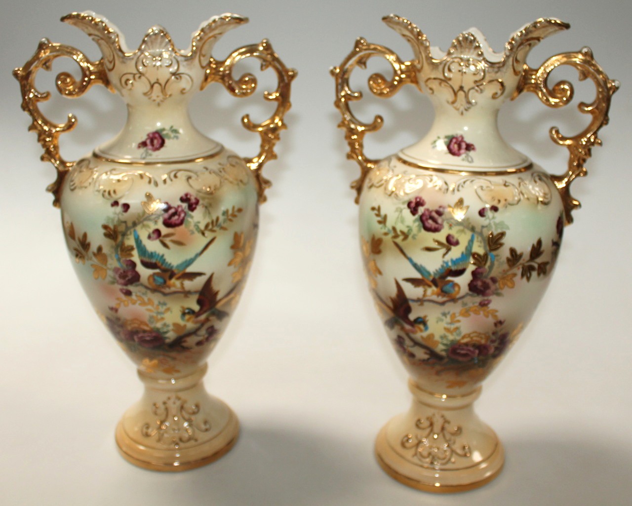 Appraisal: A pair of Edwardian pottery vases each with shouldered bodies