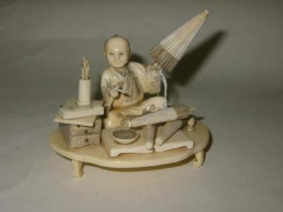 Appraisal: A JAPANESE CARVED IVORY OKIMONO Meiji period depicting a seated