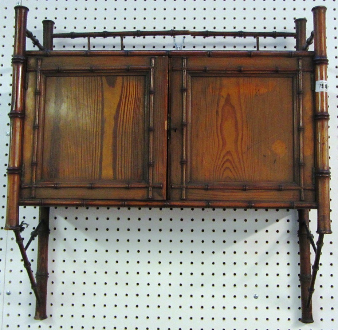 Appraisal: A th century pitch pine faux bamboo hanging two door