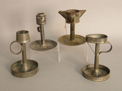 Appraisal: Four early tin lamps early th c all with reservoirs