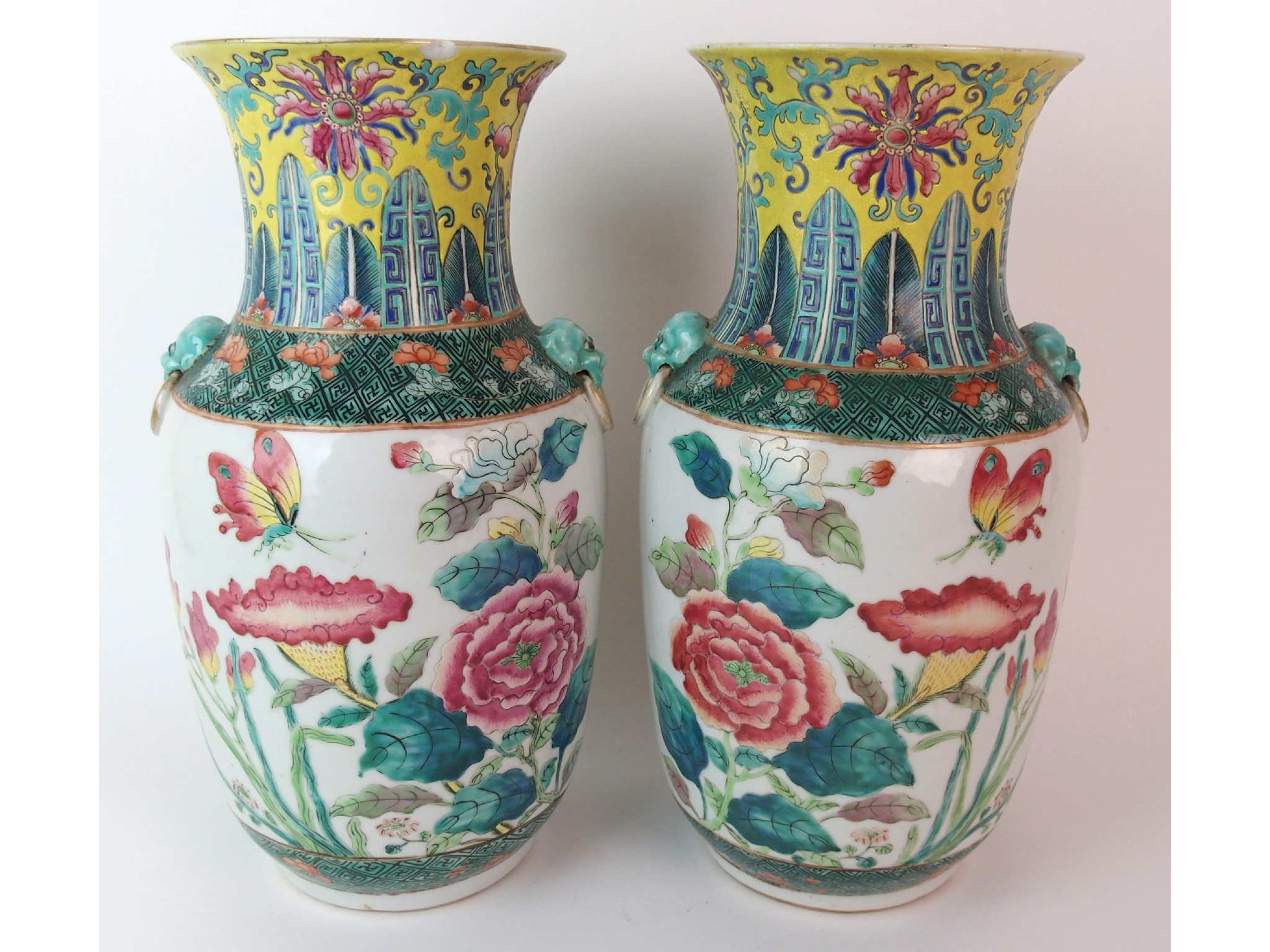 Appraisal: A pair of Chinese famille rose verte vasespainted with butterflies