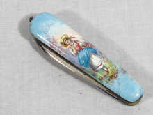 Appraisal: A pocket knife with enamel on copper guards depicting young