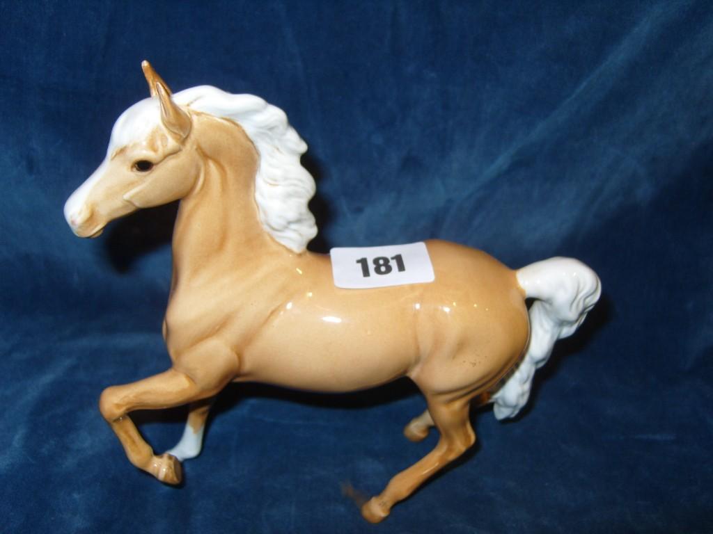 Appraisal: A Beswick model of a palomino pony with raised foreleg