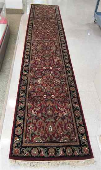 Appraisal: HAND KNOTTED ORIENTAL CORRIDOR RUG Indo-Persian overall floral design on